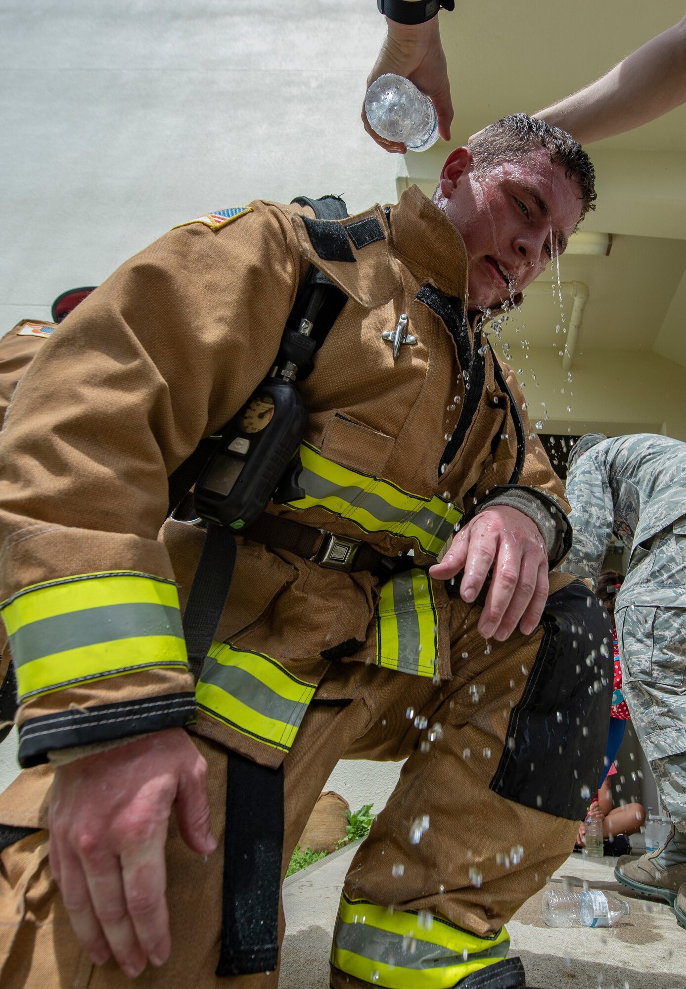 U.S. Air Force Senior Airman Forrest Privette, 18th Civil Engineer Squadron driver operator, cools down after climbing 110 flights of stairs during the Kadena Fire Emergency Services 9/11 Memorial Stair Climb Sept. 11, 2018, at Kadena Air Base, Japan. The event was held to honor the sacrifices 417 first responders made during the Sept. 11, 2001, terrorist attacks at the World Trade Center in N.Y. (U.S. Air Force photo by Staff Sgt. Micaiah Anthony)