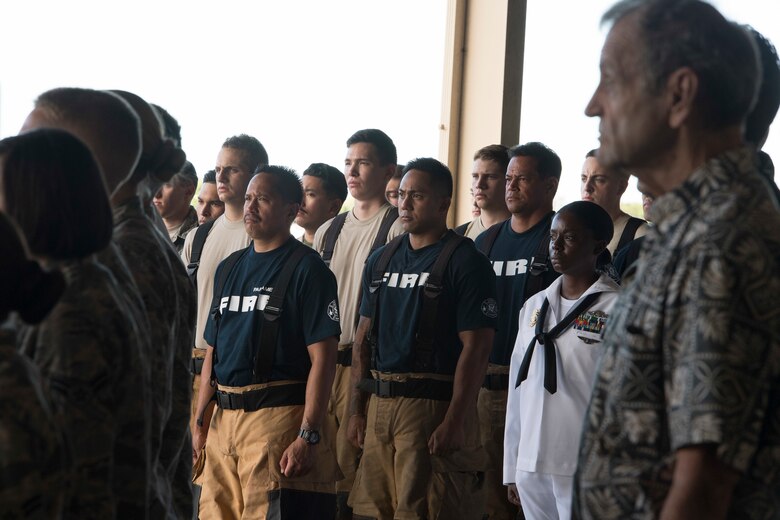 U.S. Air Force Tech. Sgt. Justin Sabio, center, a firefighter with the Air Force Reserve’s 624th Regional Support Group, stands among first responders during a 9/11 Remembrance Ceremony at the Hickam Field Fire Department at Joint Base Pearl Harbor-Hickam, Hawaii, Sept. 11, 2018. Sabio works full time with the Navy Federal Fire as an advanced emergency medical technician and serves part-time as a firefighter with the 624th Civil Engineer Squadron. The ceremony honored the heroic actions of first responders who answered the nation’s call that fateful day and recognized men and women who currently serve. (U.S. Air Force photo by Master Sgt. Theanne Herrmann)