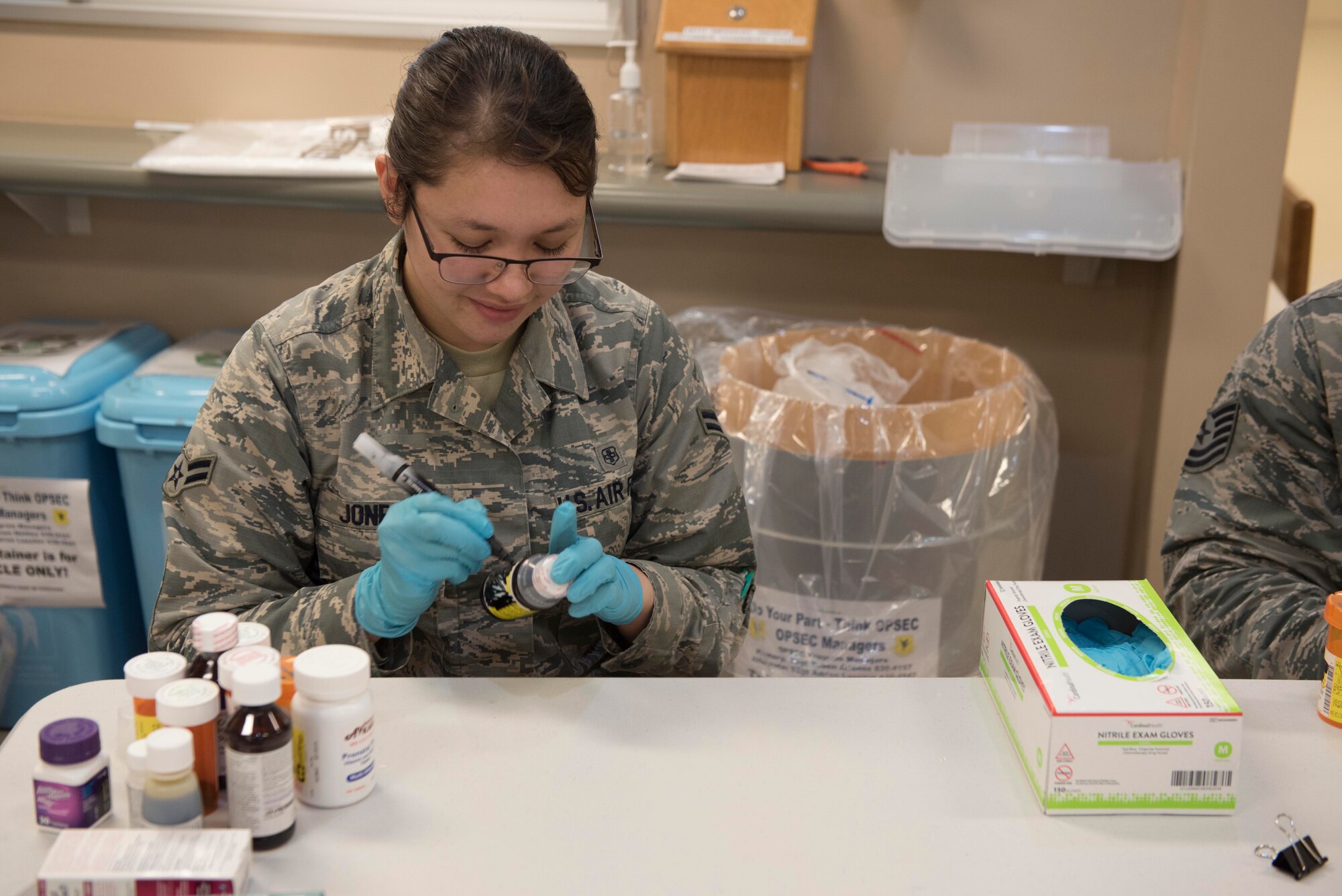 U.S. Air Force Airman 1st Class Courtney Jones, 18th Medical Group medical records technician, covers personal information on prescription bottles Sept. 10, 2018, at Kadena Air Base, Japan. The 18th MDG hosts annual turn-in days for expired or unneeded prescription and non-prescription drugs. Collected medications are disposed of according to military and Japanese standards.