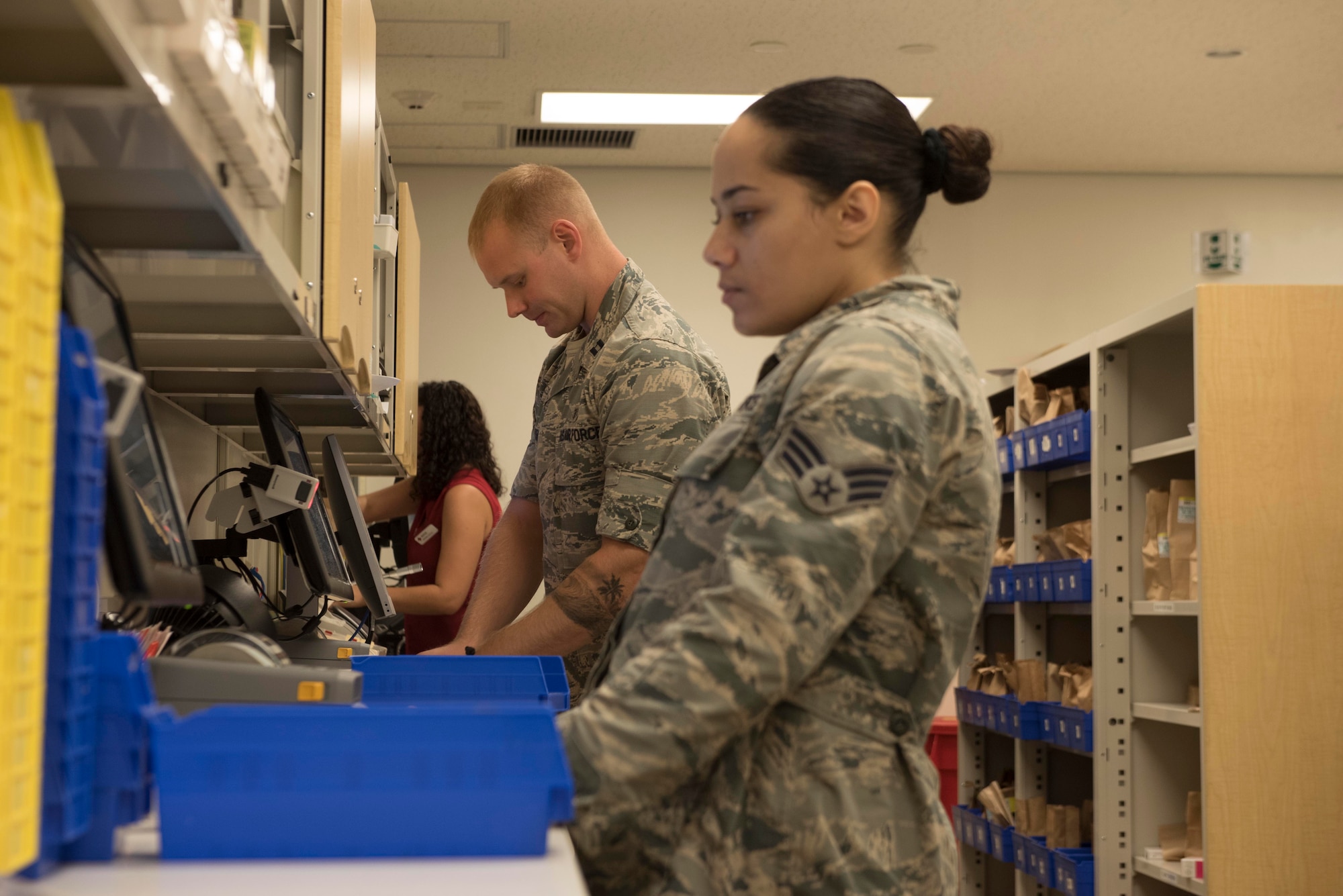 U.S. Air Force Senior Airman Cheyenne Wright, 18th Medical Group pharmacy technician, and Capt. Allen Houser, 18th MDG pharmacy operations officer-in-charge, check and fill prescriptions Sept. 10, 2018, at Kadena Air Base, Japan. Technicians ensure patients receive the appropriate number of the correct tablets as determined by their medical providers.