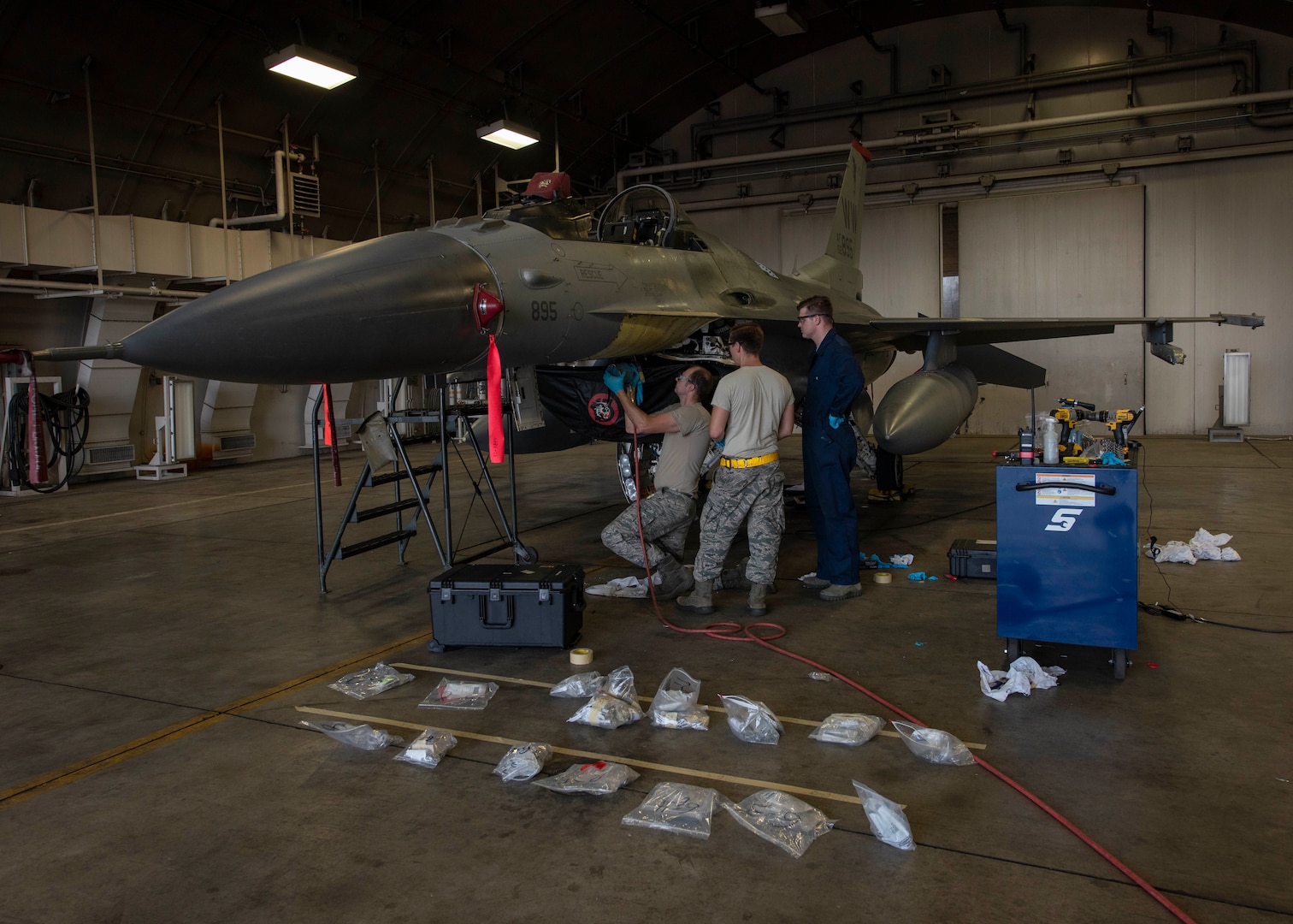 U.S. Air Force Tech. Sgt. Jordon Jones, left, Staff Sgt. Charles White, center, both aircraft structural maintenance craftsman, and Senior Airman Jaceb Brammer, right, an aircraft structural maintenance journeyman, all with the 35th Maintenance Squadron, inspect an F-16 Fighting Falcon at Misawa Air Base, Japan, Aug. 24, 2018. The team discovered corrosion on the lower skin of the aircraft, making it inoperable until repair. Typically the repair would be performed by either depot-level maintainers or contractors, however, the F-16 System Program Office at Hill Air Force Base approved Misawa Airmen to rectify the issue. (U.S. Air Force photo by Airman 1st Class Collette Brooks)