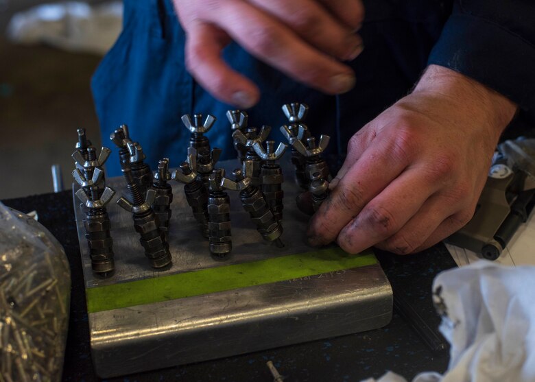 U.S. Air Force Senior Airman Jaceb Brammer, a 35th Maintenance Squadron aircraft structural maintenance journeyman, picks up a maintenance tool to make a repair, on an F-16 Fighting Falcon at Misawa Air Base, Japan, Aug. 24, 2018. The sheet metal repair conducted at the 13th MXS, took approximately four months to complete in comparison to the 10 months it would have taken if sent to the state-side depot at Hill Air Force Base, Utah, for repair. (U.S. Air Force photo by Airman 1st Class Collette Brooks)