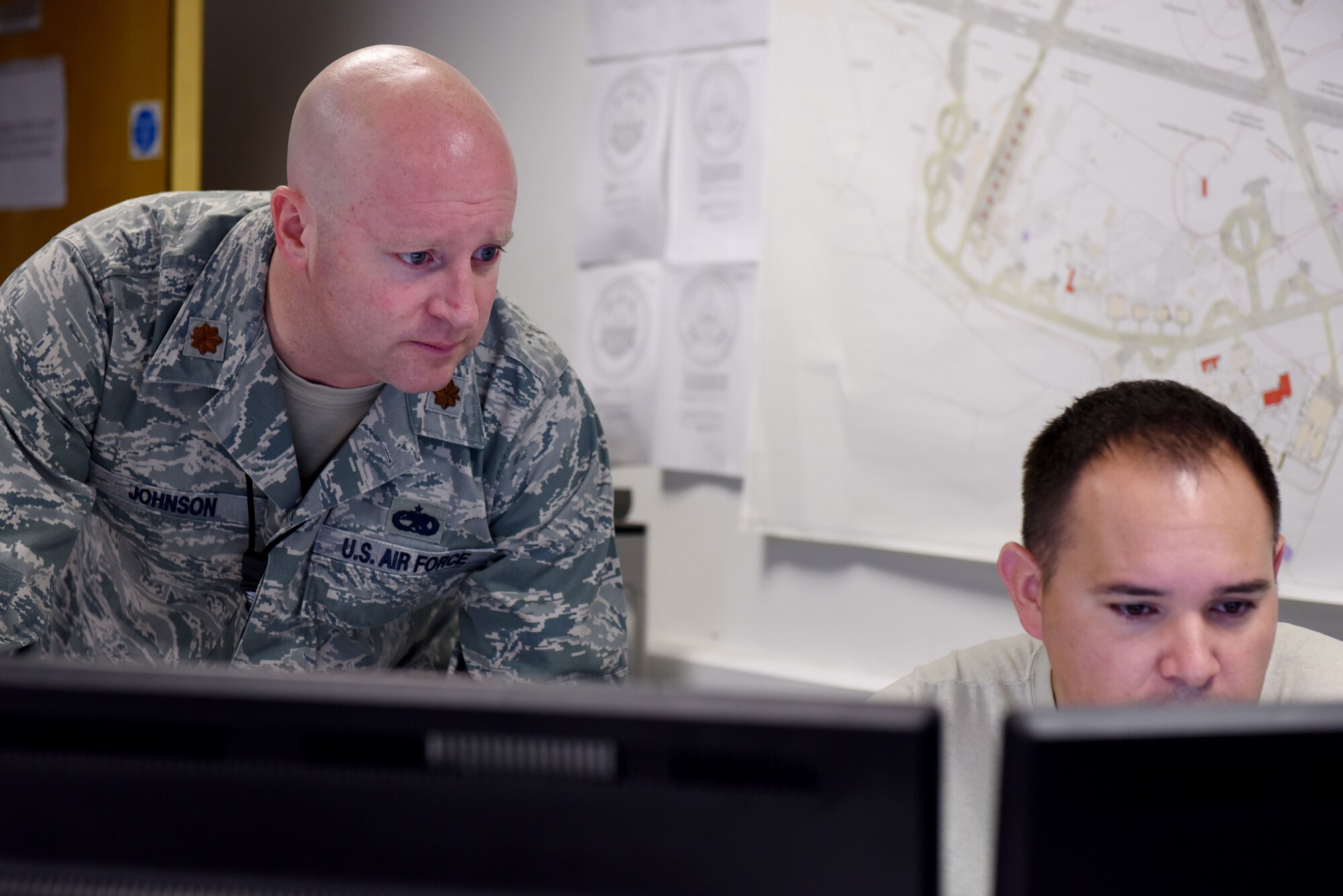 U.S. Air Force Maj. Phillip Johnson, 100th Aircraft Maintenance Squadron maintenance operations officer, and Master Sgt. Sammy Hicks, 100th Aircraft Maintenance Squadron production supervisor, review the status of aircraft at RAF Mildenhall, England, Aug. 23, 2018.  Johnson is an aircraft maintenance officer from the Tennessee Air National Guard serving a 90 day deployment at RAF Mildenhall. (US. Air Force photo by Senior Airman Lexie West)