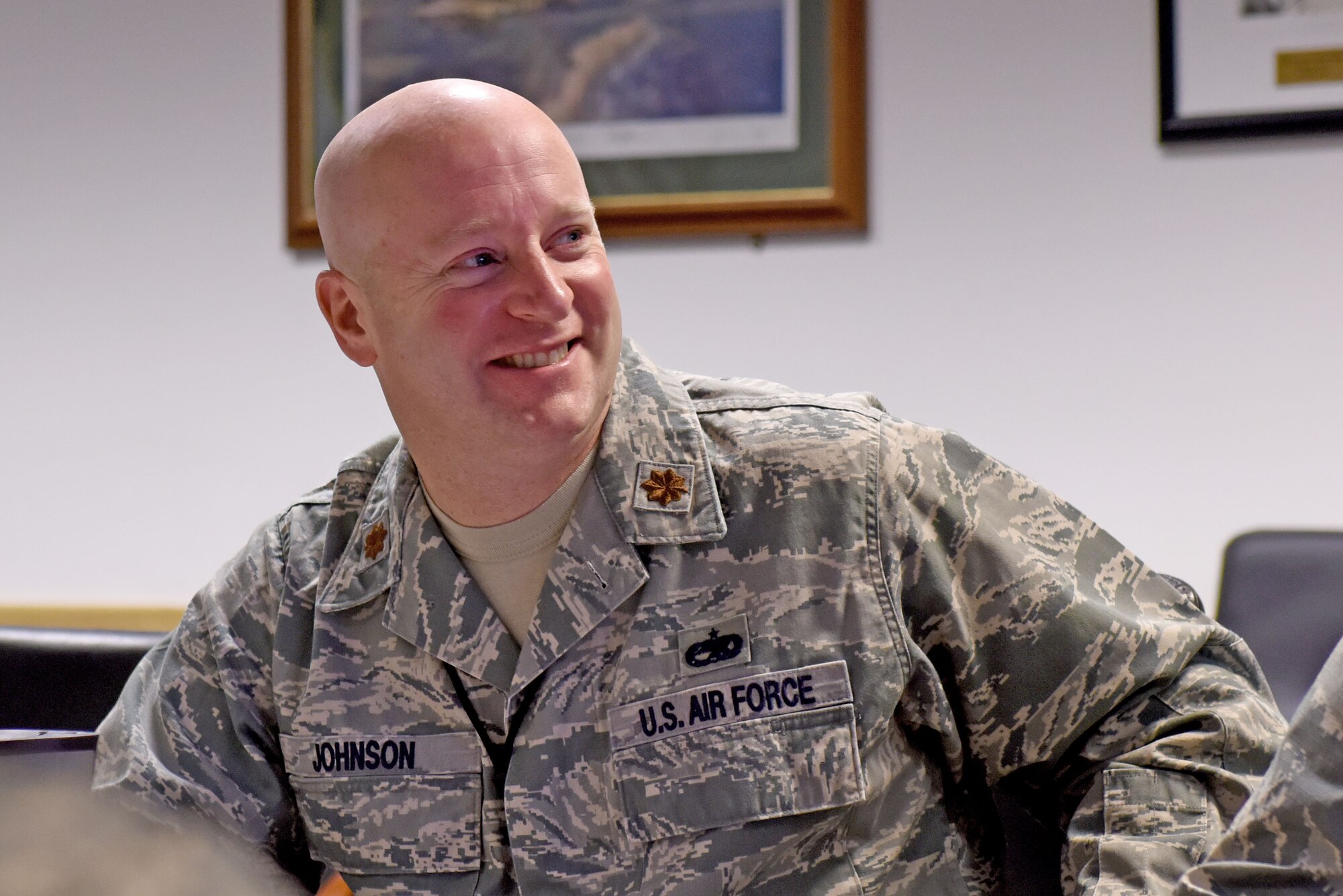 U.S. Air Force Maj. Phillip Johnson, 100th Aircraft Maintenance Squadron maintenance operations officer, smiles during an aircraft maintenance production meeting at RAF Mildenhall, England, Aug. 23, 2018. A member of the Tennessee Air National Guard, Johnson is fulfilling a 90 day deployment at RAF Mildenhall as part of Total Force Integration.  (US. Air Force photo by Senior Airman Lexie West)