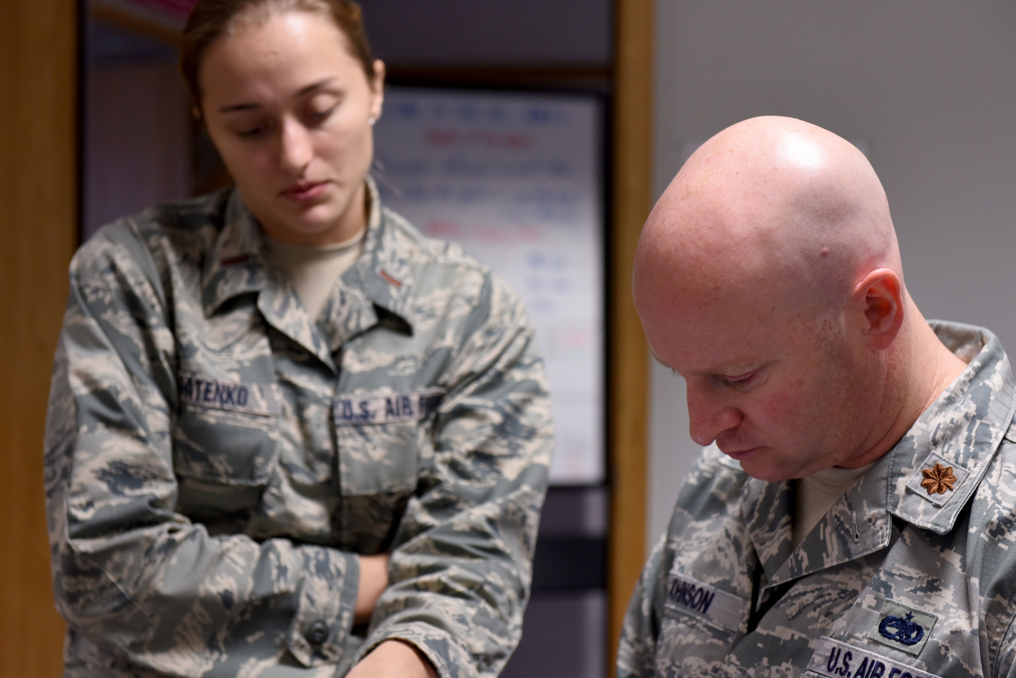U.S. Air Force Maj. Phillip Johnson, 100th Aircraft Maintenance Squadron maintenance operations officer, discusses plans with 2nd Lt. Yelizaveta Patenko, 100th Aircraft Maintenance Squadron flight commander, at RAF Mildenhall, England, Aug. 23, 2018.  A member of the Tennessee Air National Guard, Johnson is fulfilling a 90 day deployment at RAF Mildenhall as part of Total Force Integration.  (US. Air Force photo by Senior Airman Lexie West)
