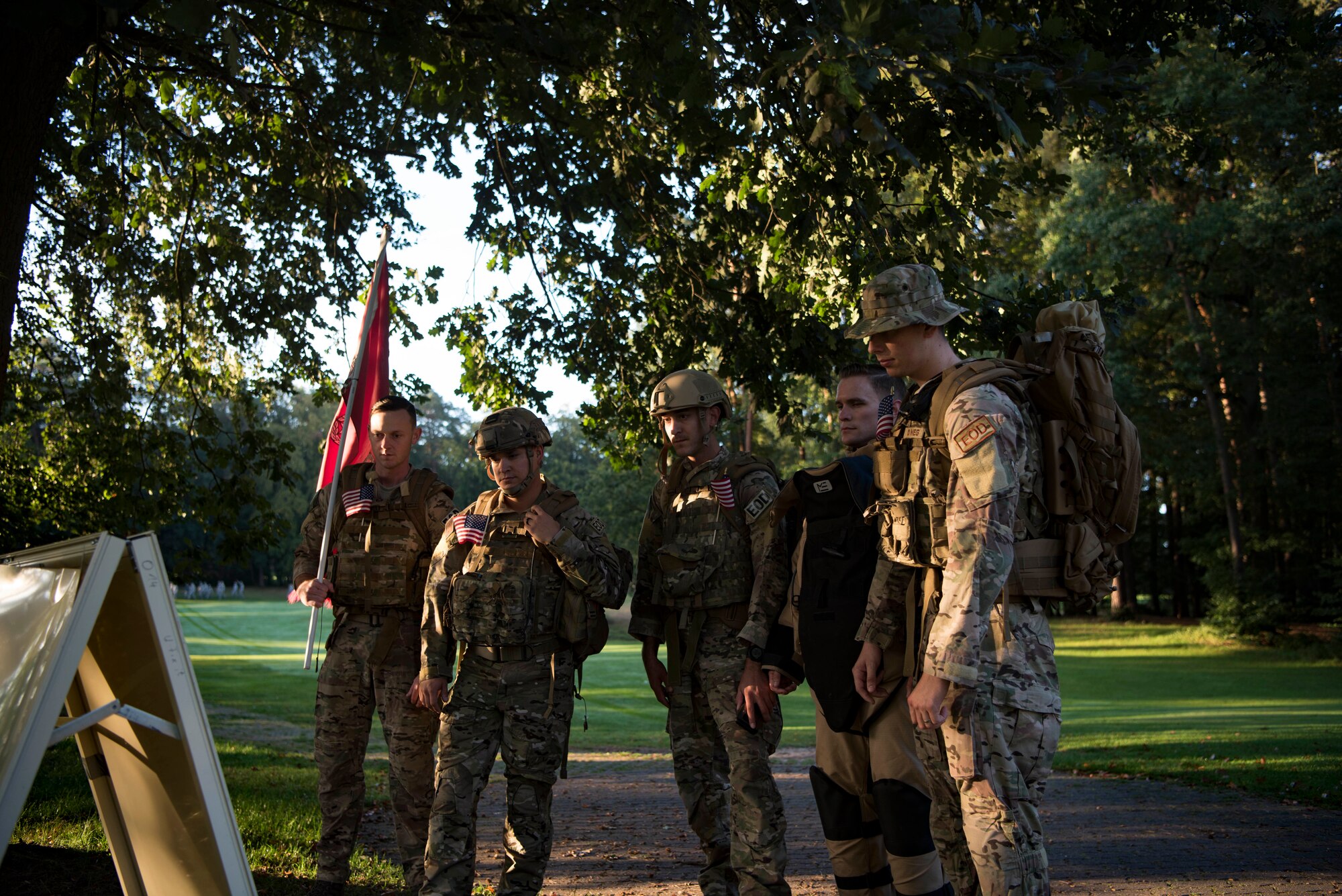 U.S. Air Force Airmen from the 786th Civil Engineer Squadron Explosive Ordnance Disposal flight read one of the 18 graphics found throughout the golf course on Ramstein Air Base, Germany, Sep. 11, 2018. Each graphic shared a picture and story on a U.S. service member who went above and beyond the call of duty.