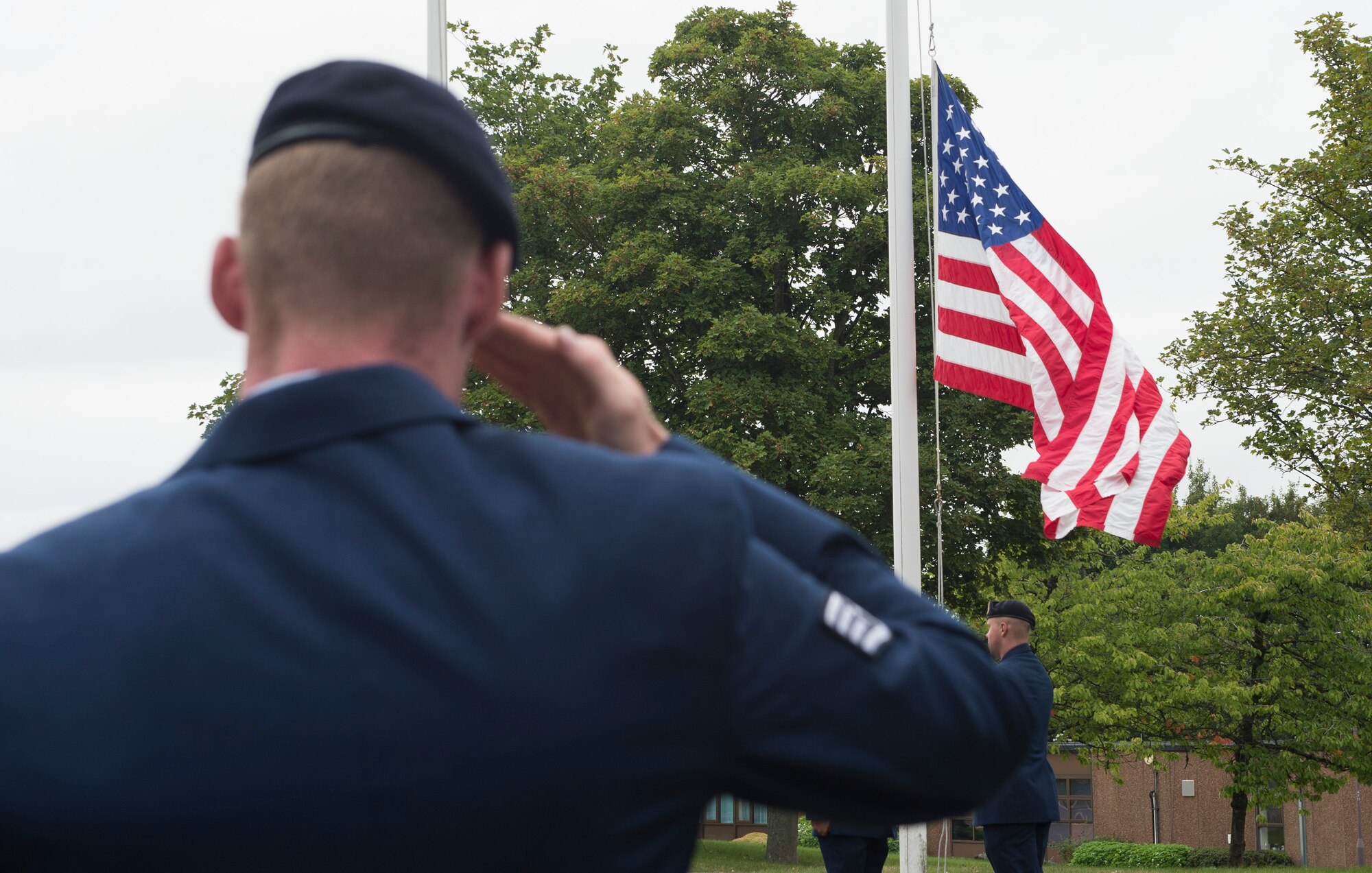 An Airman from the 423rd Security Forces Squadron salutes the United States flag in honor of Sept. 11 at RAF Croughton, United Kingdom, Sept. 11, 2018. RAF Croughton payed respects by holding a retreat ceremony and speech. (U.S. Air Force photo by Senior Airman Chase Sousa)