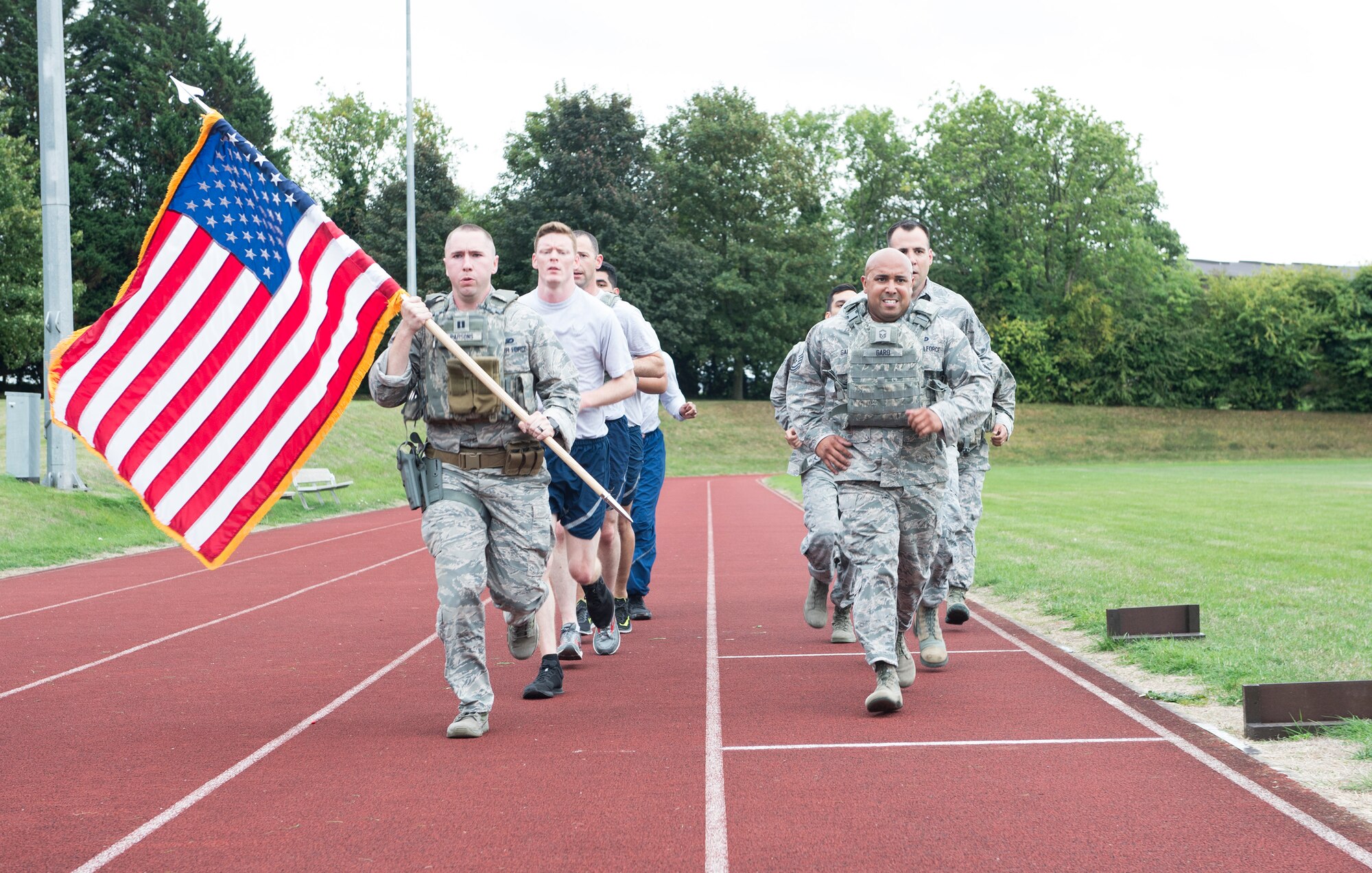 Airmen from the 423rd Security Forces Squadron run in honor of Sept. 11 at RAF Croughton, United Kingdom, Sept. 11, 2018. The U.S. flag was carried by various base agencies throughout the day. (U.S. Air Force photo by Senior Airman Chase Sousa)