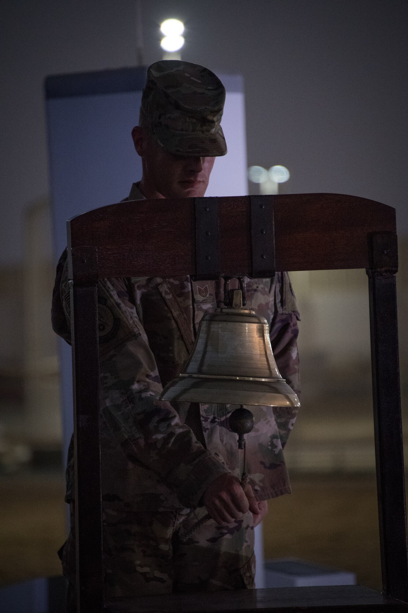 U.S. Air Force Tech. Sgt. Joshua Miles rings a ceremonious bell honoring the first responders who died during the attack 17 years ago on the World Trade Center, Al Dhafra Air Base, United Arab Emirates. Sept. 11, 2018.  (U.S. Air Force photo by Tech. Sgt. Nieko Carzis)
