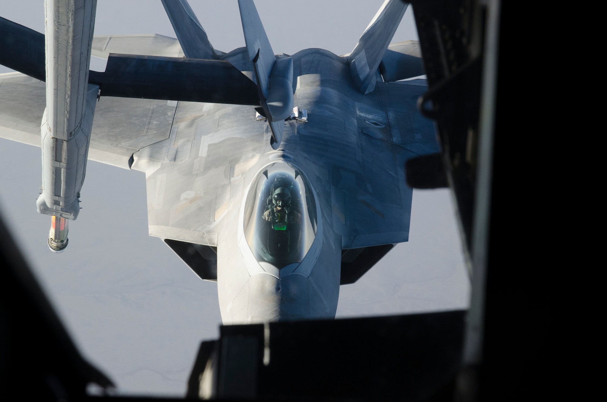 An F-22 aligns with a KC-10 over the skies of Southwest Asia.