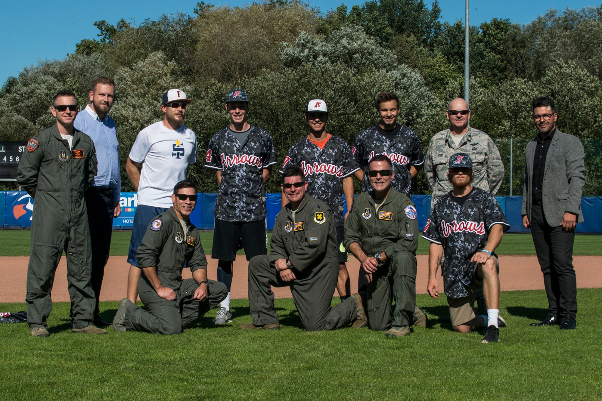 A U.S. Air Force Reserve aircrew assigned to the 307th Bomb Wing at Barksdale Air Force Base, La., takes a photo with players from the Arrows Baseball Club on Sept. 12, 2018, Ostrava, Czech Republic. The Airmen are in Ostrava to support the NATO Days airshow, which consists of the presentation of heavy military hardware, police and rescue equipment, dynamic displays of Special Forces training, flying displays, and presentation of armaments, equipment and military gear. (U.S. Air Force photo by Master Sgt. Greg Steele)