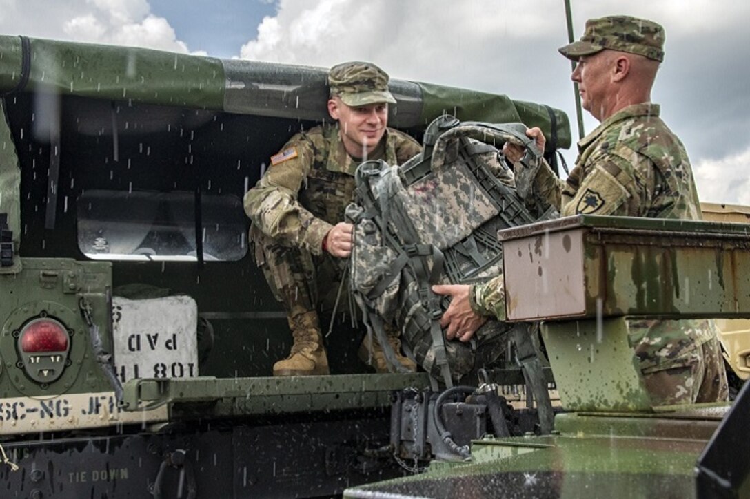 Ahead of Hurricane Florence, South Carolina Army National Guard members load gear into a Humvee in Eastover, S.C.