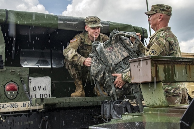 Ahead of Hurricane Florence, South Carolina Army National Guard members load gear into a Humvee in Eastover, S.C.