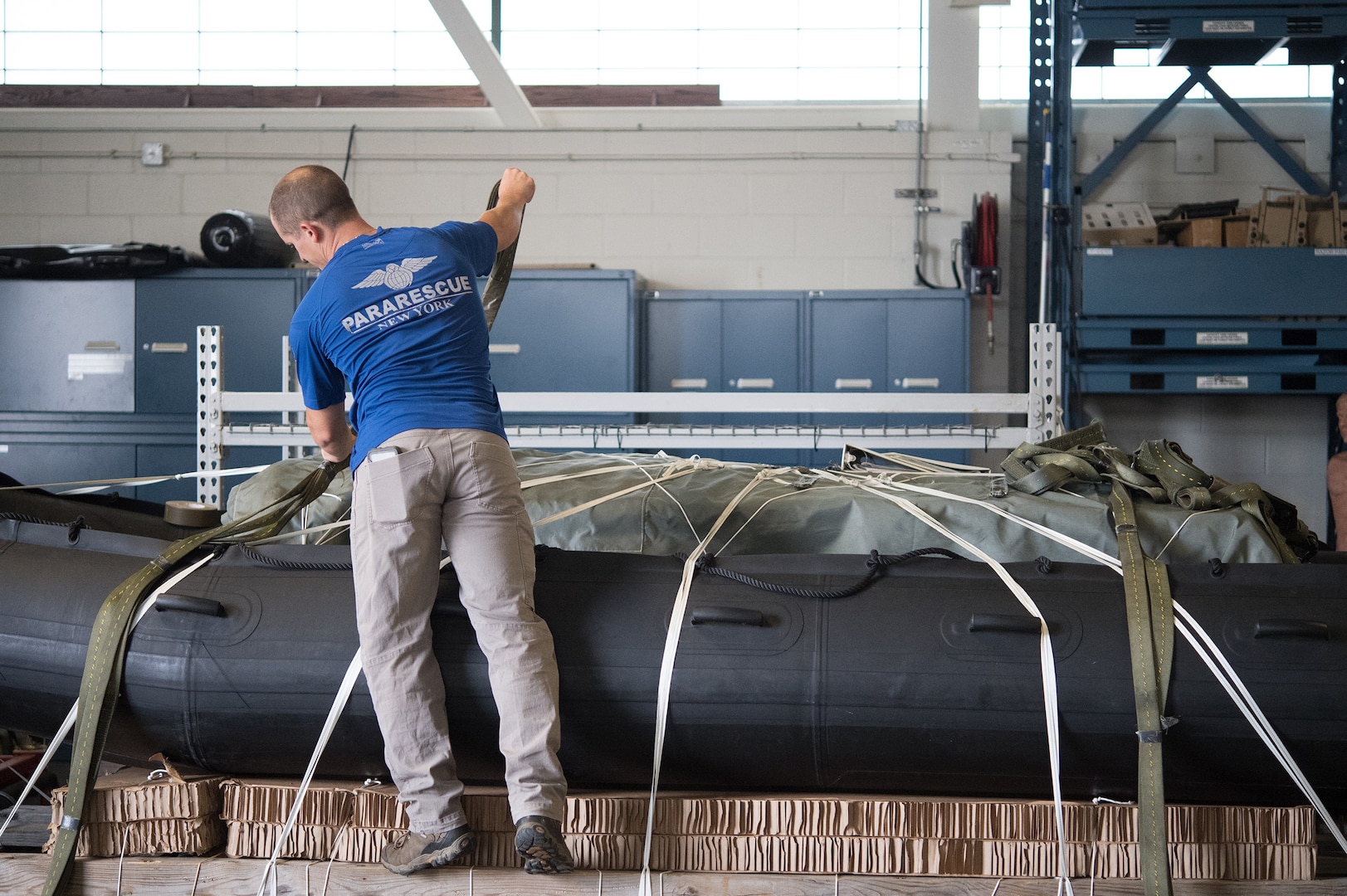 U.S. Air Force Senior Airman Peter Zaccariello, a pararescueman assigned to the 106th Rescue Wing, New York Air National Guard, checks and loads rescue equipment in preparation for Hurricane Florence Relief Operations, September 12, 2018.