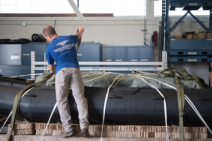 U.S. Air Force Senior Airman Peter Zaccariello, a pararescueman assigned to the 106th Rescue Wing, New York Air National Guard, checks and loads rescue equipment in preparation for Hurricane Florence Relief Operations, September 12, 2018.