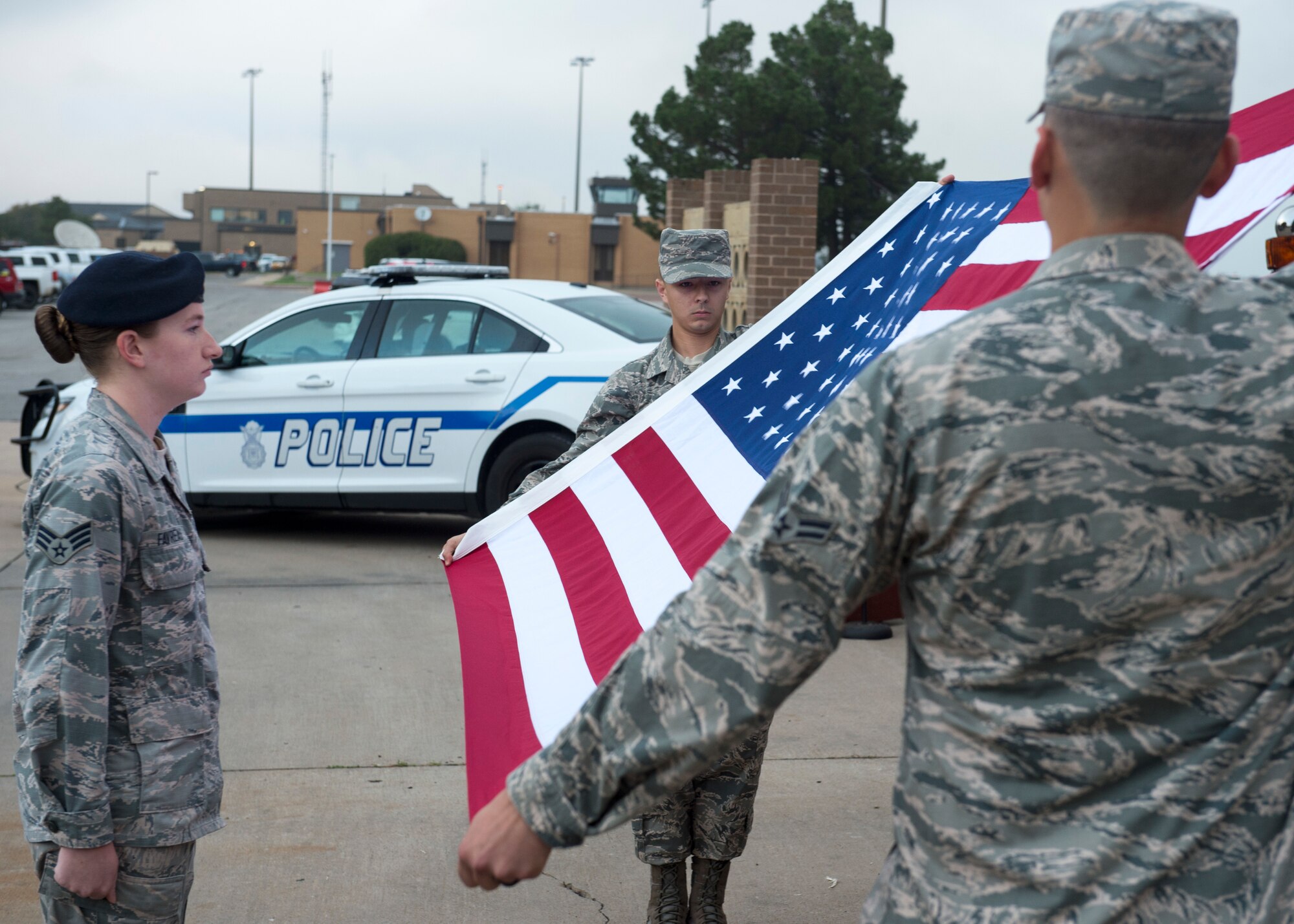 Airmen from the 97th Air Mobility Wing fold the United States Flag during the 9/11 Remembrance ceremony, Sept. 11, 2018, at Altus Air Force Base, Okla. The flag folding was done in honor of the first responders who made the ultimate sacrifice during the events of Sept. 11, 2001.