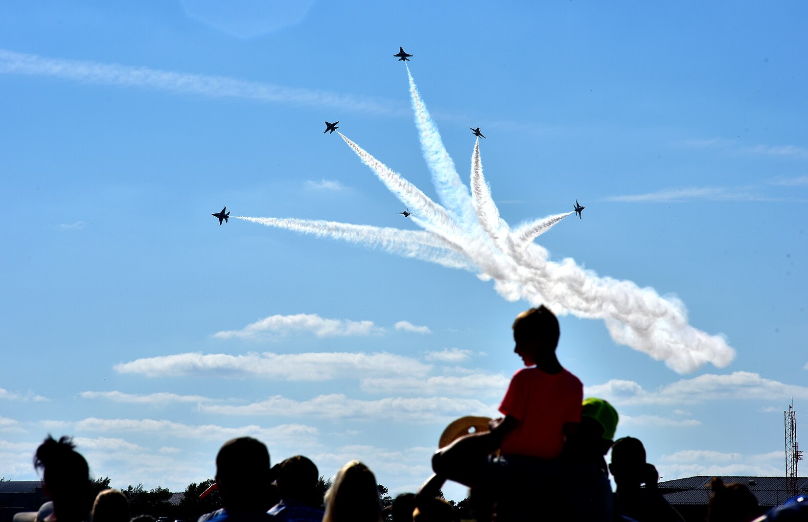 Members of the crowd watch as the Thunderbirds break formation during the Frontiers in Flight Open House and Air Show Sept. 9, 2018, at McConnell Air Force Base, Kansas. Pilots from across the Air Force, with all different backgrounds are selected to fly for the Thunderbirds. (U.S. Air Force photo by Staff Sgt. Trevor Rhynes)