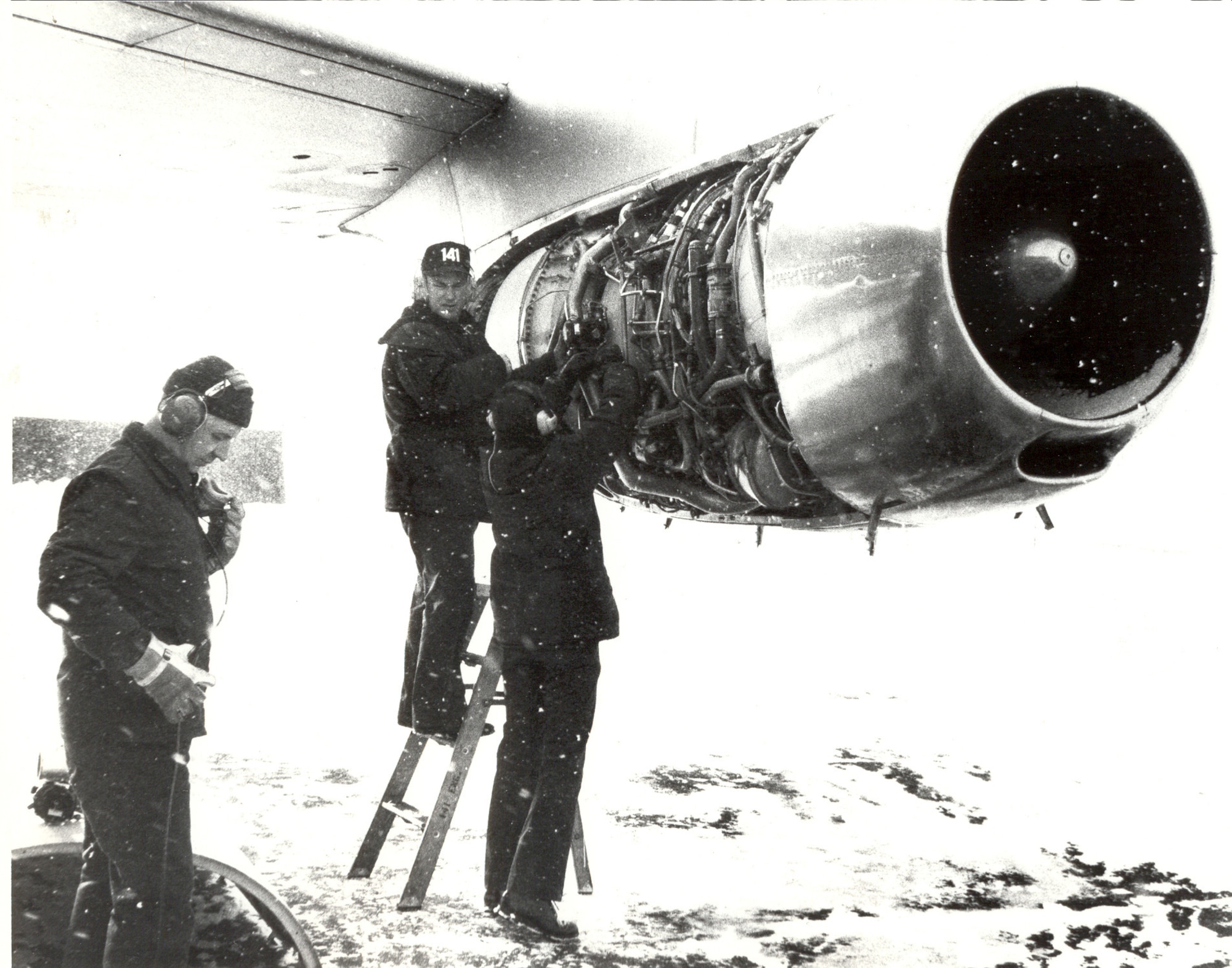 141st Air Refueling Wing maintainers work on a KC-135A in the snow December of 1976. (U.S. Air Force courtesy photo)