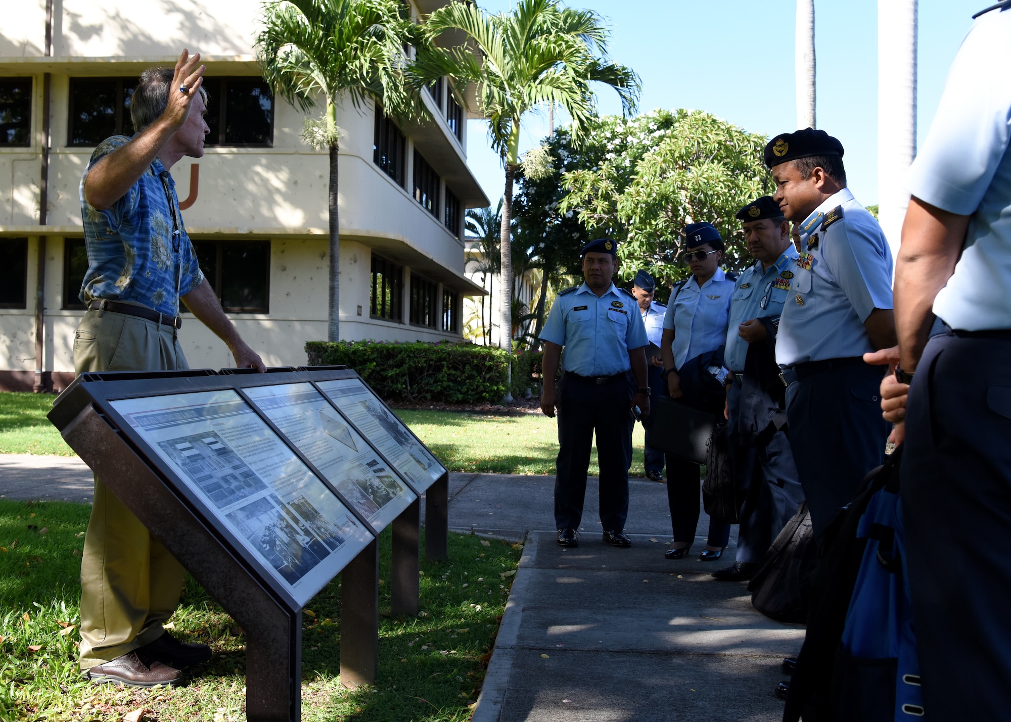 Members of the Royal Malaysian Air Force (RMAF) listen to Charles Nicholls, U.S. Pacific Air Forces (PACAF) historian, during a PACAF Headquarters and Courtyard of Heroes tour on Joint Base Pearl Harbor-Hickam, Hawaii, Sept. 5, 2018.