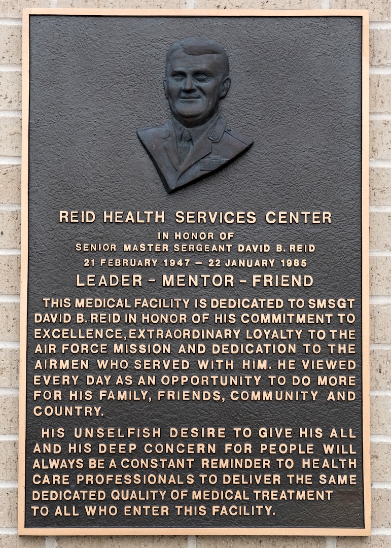 The new Reid Health Services Center bears the original bronze plaque from the 1994 dedication in honor of the late Senior Master Sgt. David B. Reid, a former first sergeant who was killed in a C-130 plane crash in 1985. The new clinic is sited on Joint Base San Antonio-Lackland, Texas, adjacent to the previous Reid Clinic located on the south edge of the new Basic Military Training Complex. (U.S. Air Force photo by Staff Sgt. Kevin Iinuma)