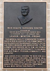 The new Reid Health Services Center bears the original bronze plaque from the 1994 dedication in honor of the late Senior Master Sgt. David B. Reid, a former first sergeant who was killed in a C-130 plane crash in 1985. The new clinic is sited on Joint Base San Antonio-Lackland, Texas, adjacent to the previous Reid Clinic located on the south edge of the new Basic Military Training Complex. (U.S. Air Force photo by Staff Sgt. Kevin Iinuma)