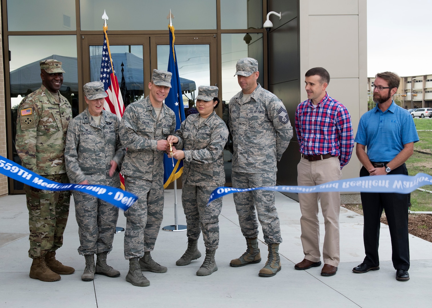 Members from the 559th Medical Group leadership along with U.S. Army Corps of Engineers, and civilian personnel cut the ribbon during the Sep. 13 opening ceremony for the new Reid Health Services Center on Joint Base San Antonio-Lackland, Texas. The new Reid Clinic incorporates functions from four buildings into one, consisting of 19 departments, and will serve approximately 86,000 patients per year. (U.S. Air Force photo by Staff Sgt. Kevin Iinuma)