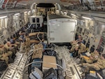 Pararescue personnel from the Alaska Air National Guard’s 212th Rescue Squadron, 176th Wing, and California ANG’s  131st Rescue Squadron, 129th Rescue Wing, settle into a AKANG’s 144th Airlift Squadron C-17 Globemaster III aircraft at Moffett Federal Airfield, Calif., Sept. 12, 2018. The Guardsmen complete with equipment, trailers and vehicles are enroute to Dover Air Force Base, Del., in preparation for offering support to civil authorities as needed in response to hurricane relief operations.