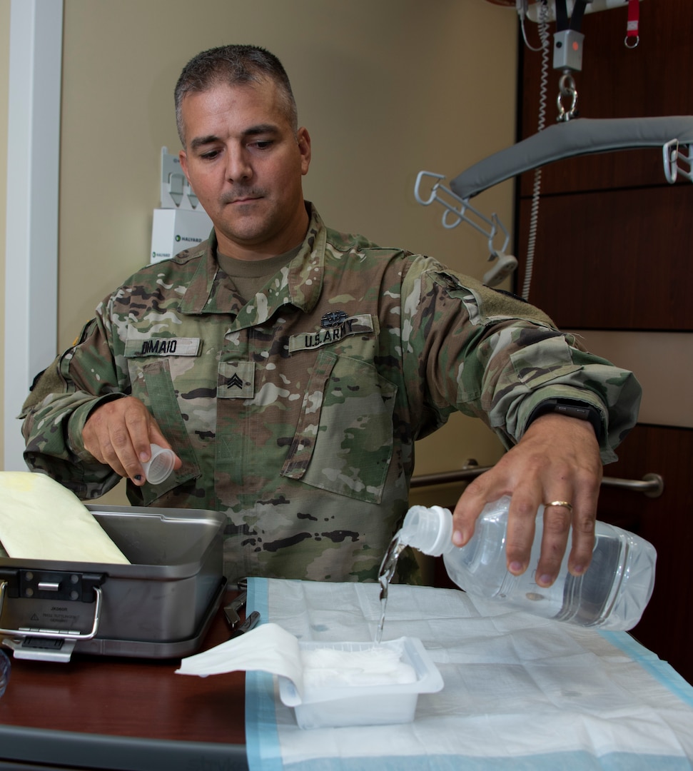 Sgt. Anthony Dimaio, noncommissioned officer in charge of Neuro Surgical Intensive Care unit, prepares to clean a pair of surgical scissors with a point of use kit Sept. 12 at Brooke Army Medical Center, Joint Base San Antonio-Fort Sam Houston. The kit is used to remove gross debris from instruments at patient bedside before being sent for sterilization. The pre-packaged kit saves the hospital roughly $300,000 to $500,000 annually.