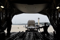 Staff Sgt. Andrea Jansen, a 16th Airlift Squadron loadmaster, guides a cargo truck into position from the ramp of a C-17 Globemaster III at Joint Base Andrews, Md., Sept. 11, 2018. In anticipation of Hurricane Florence, more than 20 aircraft were evacuated from Joint Base Charleston, S.C., to designated safe locations in order to continue their global airlift operations. Following the stop at Andrews, Jansen and her crew flew to Scott Air Force Base, Ill., for crew rest ahead of an international mission.