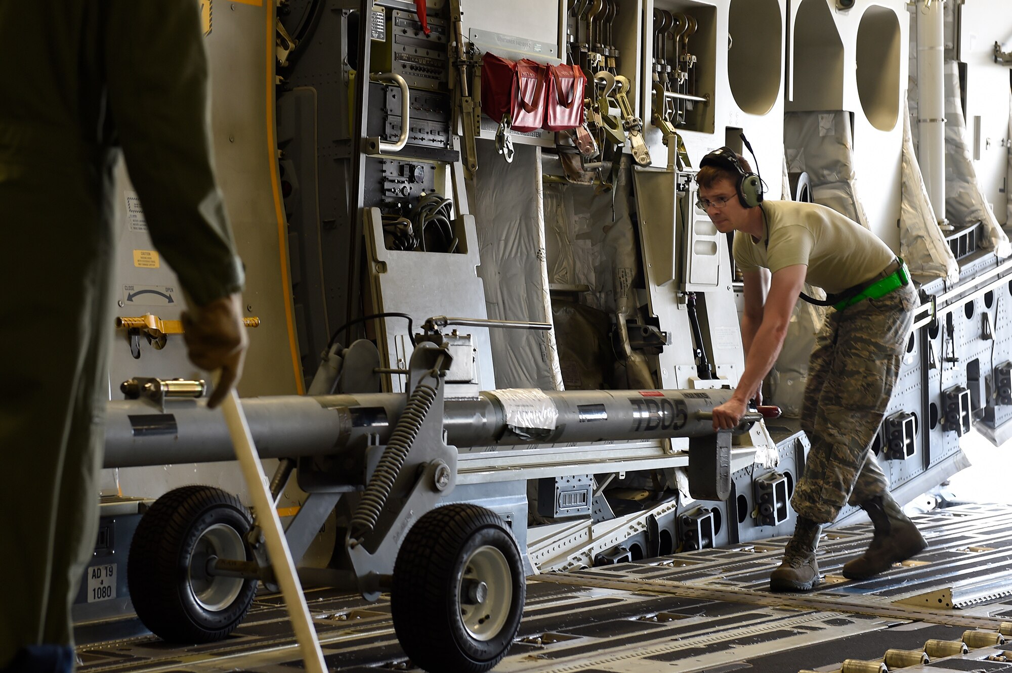 Staff Sgt. Donald Kirby, a 437th Aircraft Maintenance Squadron aerospace maintainer, moves a tow bar into its storage position on a C-17 Globemaster III at Joint Base Charleston, S.C., Sept. 11, 2018.