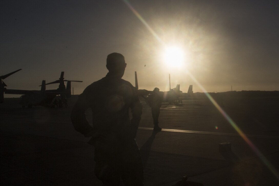 A Marine with Company F, Battalion Landing Team, 2nd Battalion, 5th Marines, waits for transportation at Marine Corps Air Station Futenma after a simulated helicopter raid, Okinawa, Japan, Aug. 20, 2018.