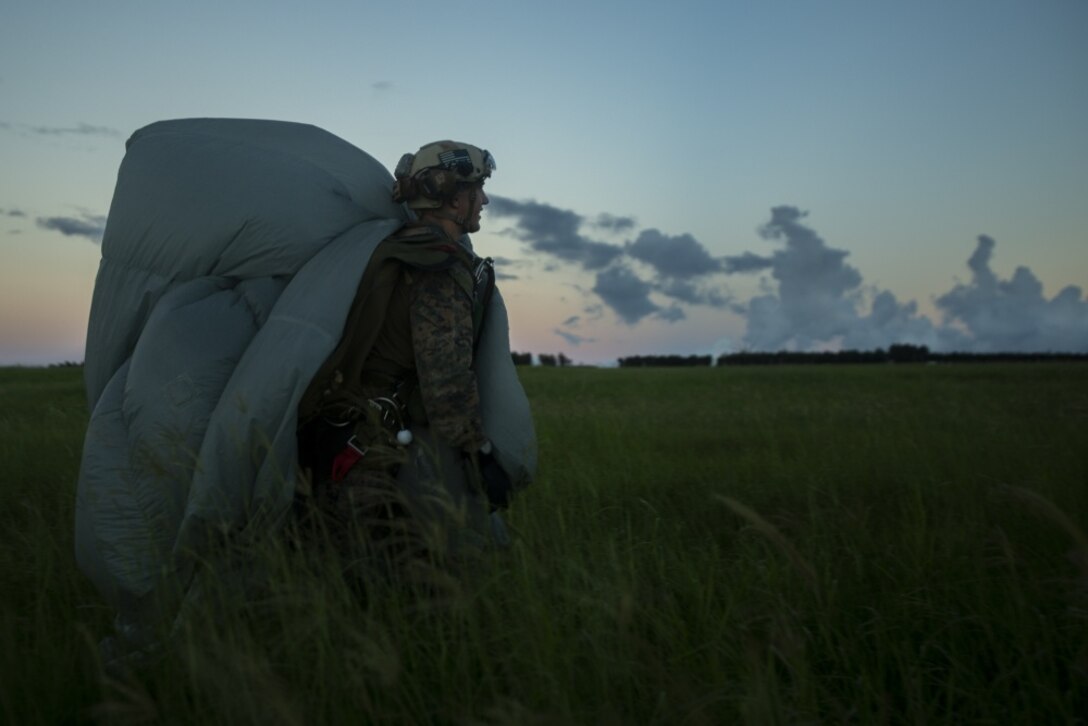 A reconnaissance Marine with the 31st Marine Expeditionary Unit’s Amphibious Reconnaissance Platoon exits the Designated Impact Point during free-fall parachute training at Ie Shima Training Facility, Okinawa, Japan, Aug. 29, 2018. The ARP Marines flew to a spot above a landing zone on Ie Shima Training Facility, off Okinawa’s northwest coast, before exiting a cruising MV-22B Osprey tiltrotor aircraft – from there, the Marines fell for approximately 50 seconds before deploying parachutes to land safely. The 31st MEU, the Marine Corps’ only continuously forward-deployed MEU, provides a flexible force ready to perform a wide-range of military operations. (U.S. Marine Corps photo by Lance Cpl. Alexis B. Betances/Released)
