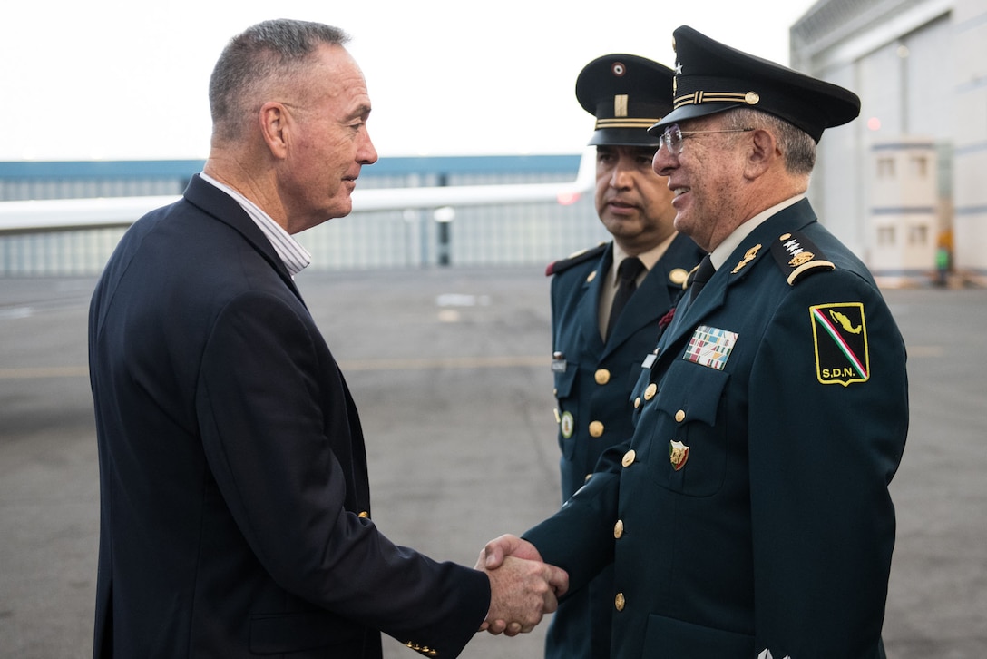 Marine Corps Gen. Joe Dunford Jr., chairman of the Joint Chiefs of Staff, shakes hands with a Mexican military official.