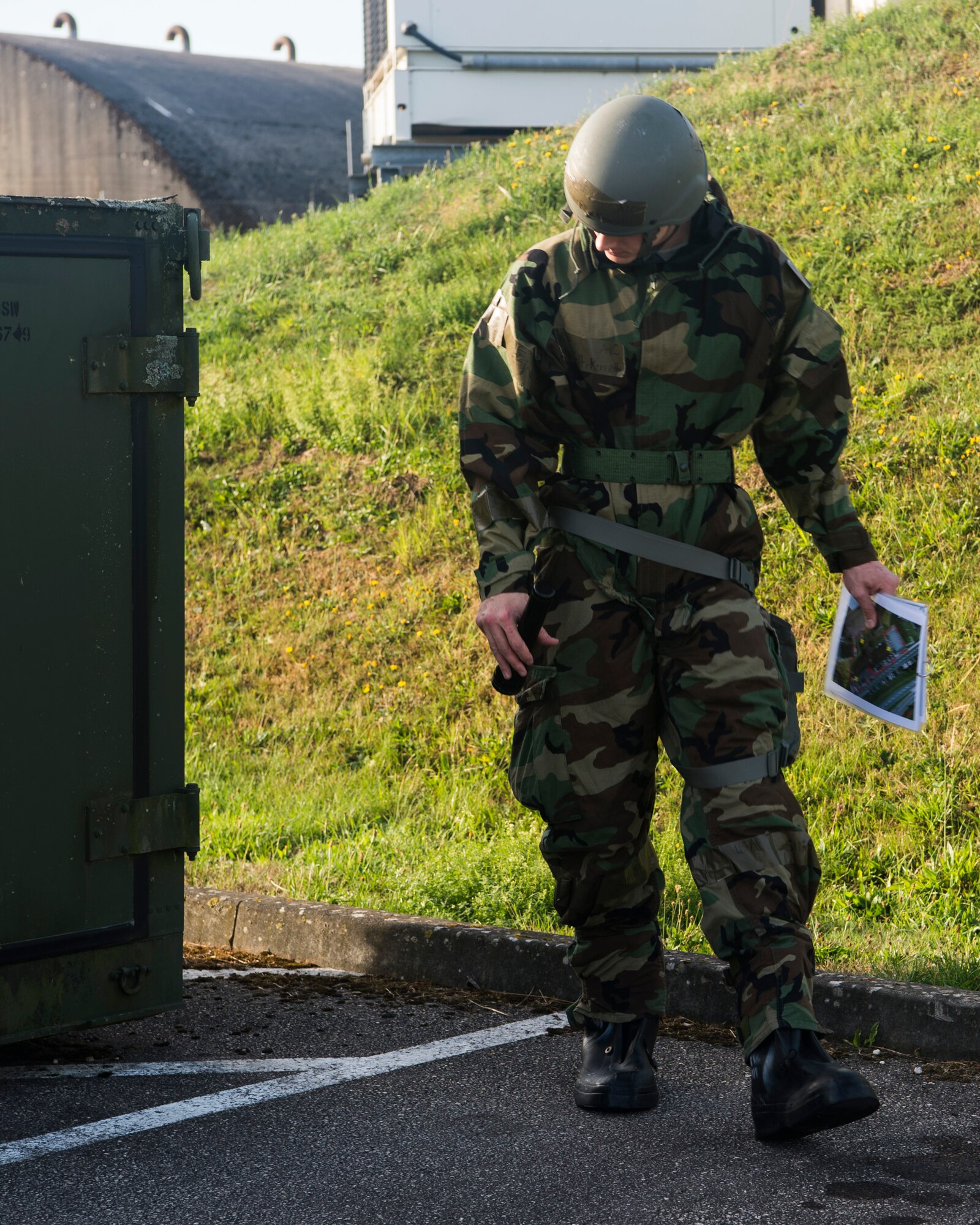 U.S. Air Force Airman 1st Class Kenneth Overfelt, 52nd Maintenance Support Squadron F-16 Phase Support team member, conducts a battlefield damage assessment check during an exercise at Spangdahlem Air Base, Germany, Sept. 11, 2018. The base-wide readiness exercise tested Airmen's abilities to execute policies, procedures, and response operations in preparation for potential real-life scenarios. (U.S. Air Force photo by Airman 1st Class Valerie Seelye)