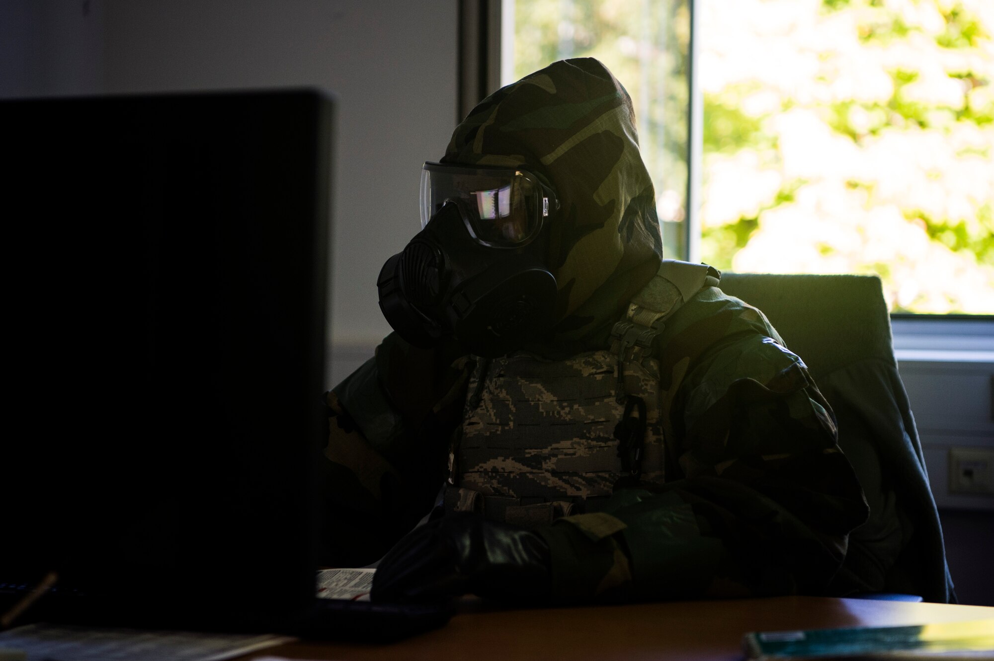 U.S. Air Force Master Sgt. Torrie Stack, 52nd Mission Support Group Logistics and Resources superintendent, performs his normal duties wearing mission-oriented protective posture gear at Spangdahlem Air Base, Germany, Sept. 12, 2018, during a base-wide readiness exercise. The event stressed the importance of being prepared for any possible chemical, biological, readiological, or nuclear threat. (U.S. Air Force photo by Airman 1st Class Valerie Seelye)
