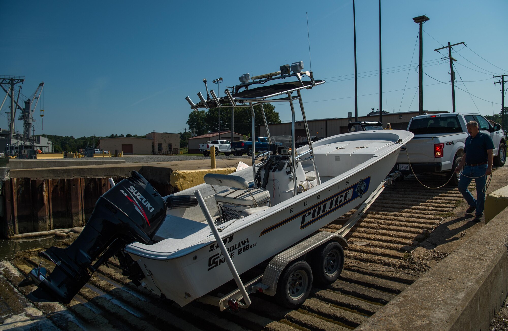 Jay Dehart, 733rd Logistics Readiness Squadron harbor master, assists in putting a police boat into the water at Joint Base Langley-Eustis, Virginia, Aug. 30, 2018.