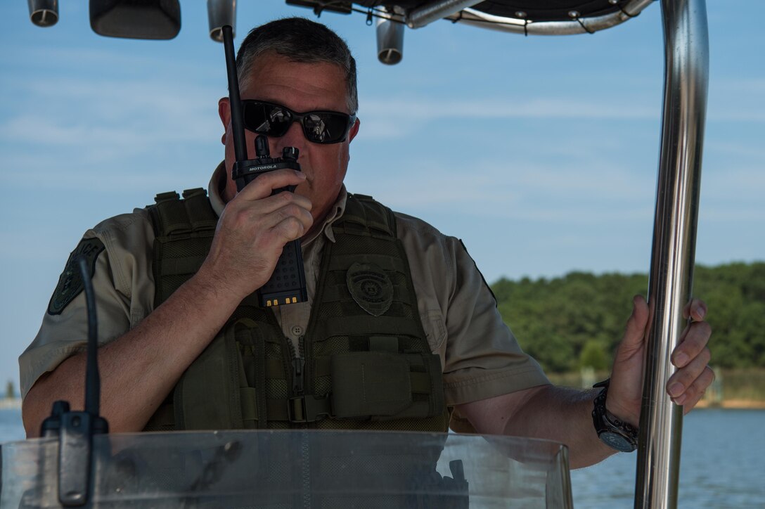 Christopher Griffin, 733rd Security Forces Squadron game warden, calls in the start of the patrol the police station at Joint Base Langley-Eustis, Virginia, Aug. 30, 2018.