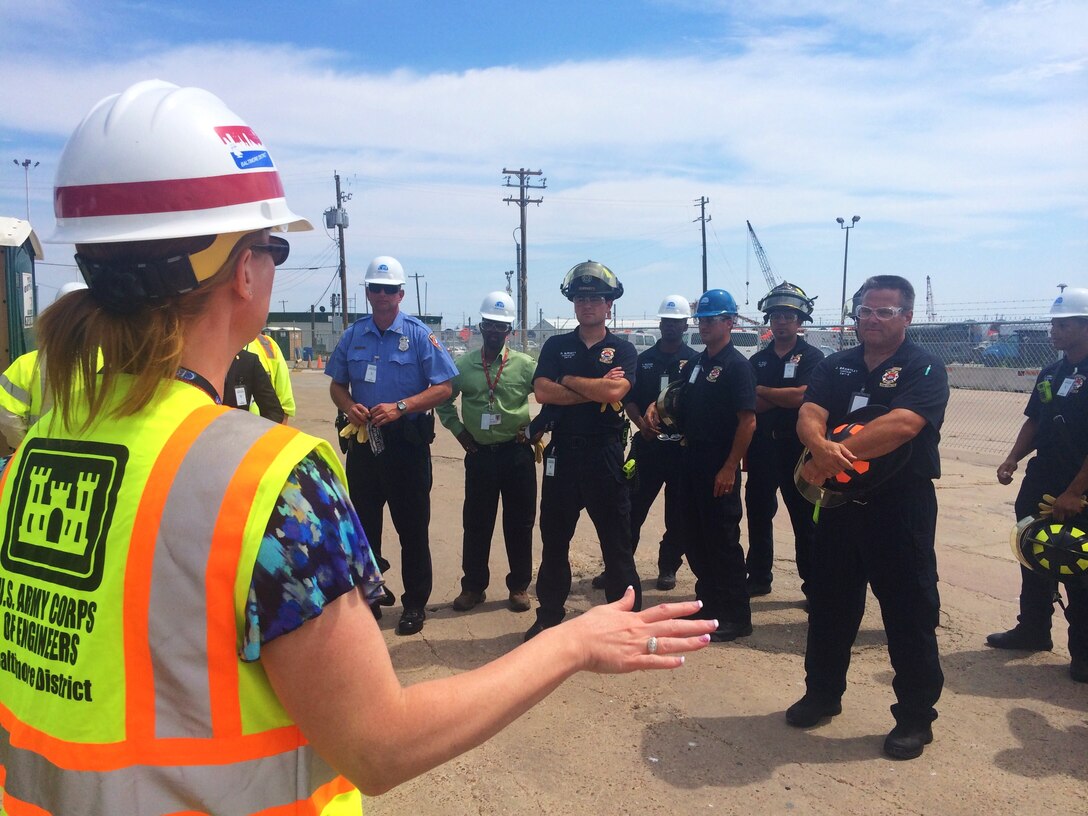 U.S. Army Corps of Engineers Project Manager Brenda Barber speaks with local officials, first responders and representatives from the U.S. Coast Guard and the Port of Galveston as part of a tour of the STURGIS June 9, 2015 in Galveston, Texas soon after the vessel arrived there for its final decommissioning. The U.S. Army Corps of Engineers coordinated closely with local partners throughout the project, especially regarding safety, and during the tour U.S. Army Corps of Engineers personnel explained the process of how the decommissioning of the barge would be completed, provided an overview of the site and reviewed safety procedures.