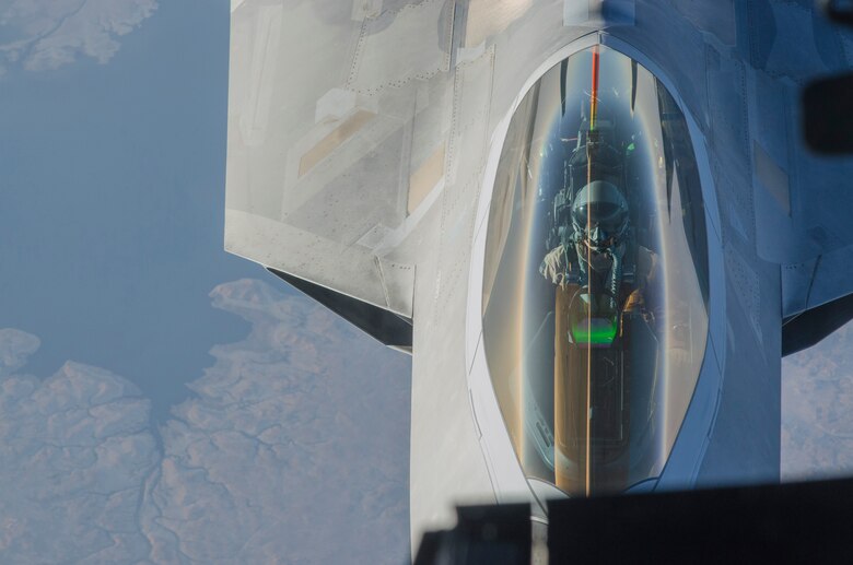An F-22 Raptor pilot from the 94th Expeditionary Fighter Squadron, Al Dhafra Air Base, United Arab Emirates, flies behind a 908th Expeditionary Air Refueling Squadron KC-10 Extender over Southwest Asia, Sept. 12, 2018. The F-22 possesses a sophisticated sensor suite allowing the pilot to track, identify, shoot and kill air-to-air threats before being detected. (U.S. Air Force photo by Staff Sgt. Ross A. Whitley)