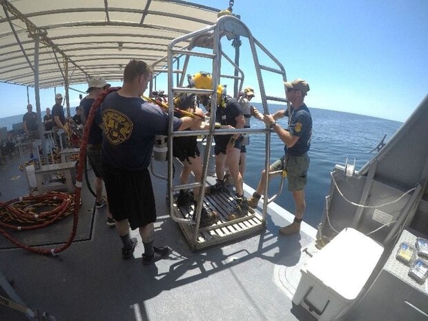 Photo By Lt. Jennifer Jewell | LCDR Nick Parker of the NEDU Reserve Detachment prepares to enter the water. He is tended by ND2 Aaron Young, also a member of the NEDU Reserve Detachment. U.S. Navy Photo by LT Jennifer Jewell.