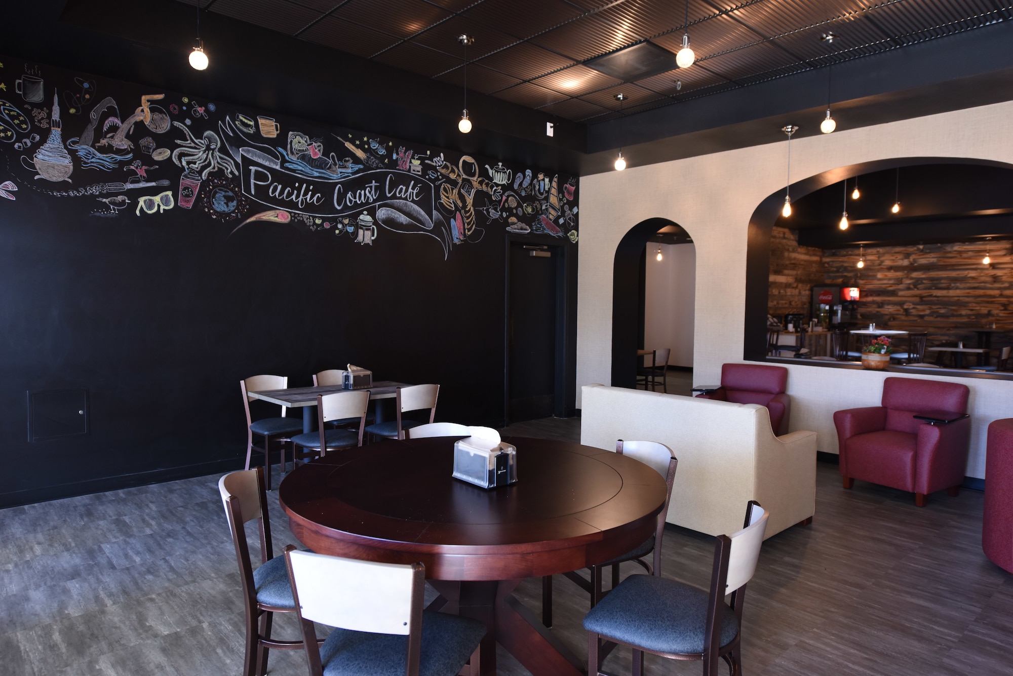 A ribbon cutting officiates the Pacific Coast Café opening September 13, 2018 at the Pacific Coast Club at Vandenberg Air Force Base, Calif. A budget was approved in February 2018 for the club to use 400,000 dollars to improve the café. (U.S. Air Force photo by Airman First Class Aubree Milks/Released)