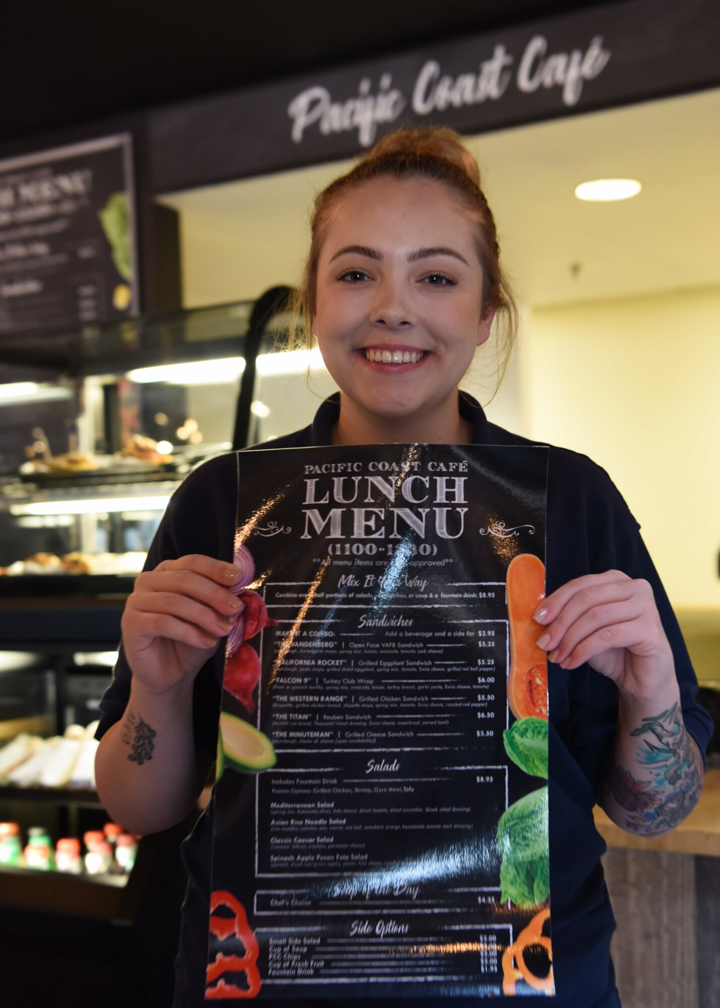 A ribbon cutting officiates the Pacific Coast Café opening September 13, 2018 at the Pacific Coast Club at Vandenberg Air Force Base, Calif. A budget was approved in February 2018 for the club to use 400,000 dollars to improve the café. (U.S. Air Force photo by Airman First Class Aubree Milks/Released)