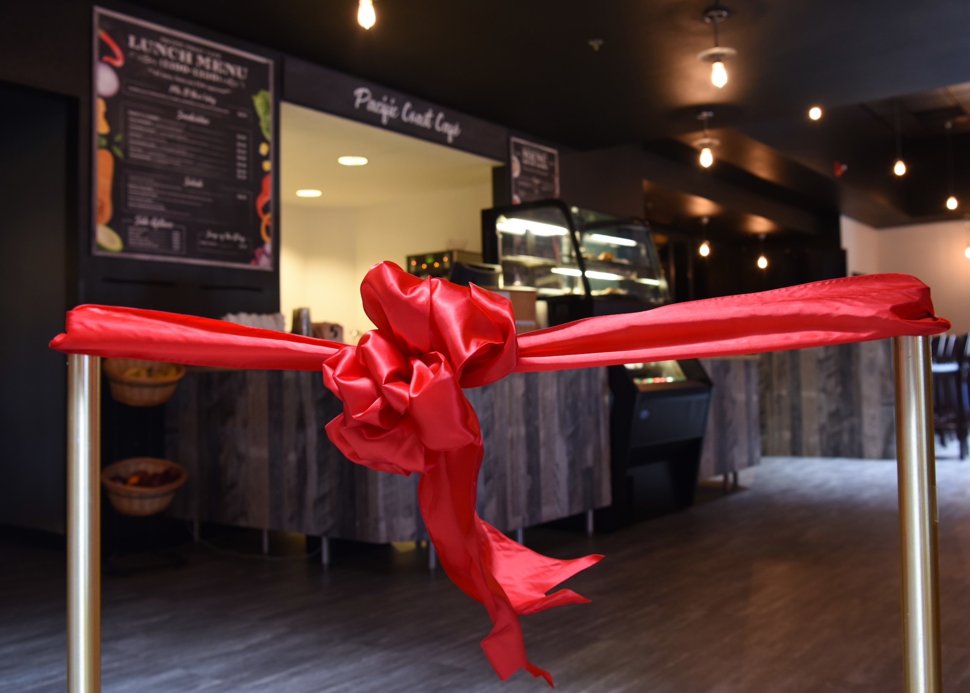 A ribbon cutting officiates the Pacific Coast Café opening September 13, 2018 at the Pacific Coast Club at Vandenberg Air Force Base, Calif. A budget was approved in February 2018 for the club to use 400,000 dollars to improve the café. (U.S. Air Force photo by Airman First Class Aubree Milks/Released)
