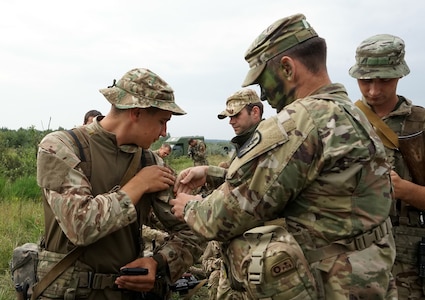 California National Guard Soldiers trade patches with Ukrainian service members at the International Peacekeeping and Security Centre in Yavoriv, Ukraine, Sept 7, 2018. During breaks in training, troops participated in the tradition of swapping patches. The troops also performed tactical training during the multinational Rapid Trident exercise.