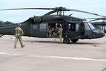 Army Sgt. Kelby Shifflett, left, and Sgt. Anthony McCall, right, UH-60 Black Hawk helicopter crew chiefs assigned to Charlie Company, 1st General Support Aviation Battalion, 169th Aviation Regiment, Oklahoma Army National Guard, conduct preflight checks.