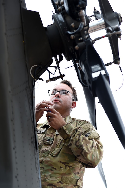 Army Spc. Benjamin Holybee, a UH-60 Black Hawk helicopter crew chief assigned to Charlie Company, 1st General Support Aviation Battalion, 169th Aviation Regiment, Oklahoma Army National Guard, conducts preflight checks in Lexington, Okla.
