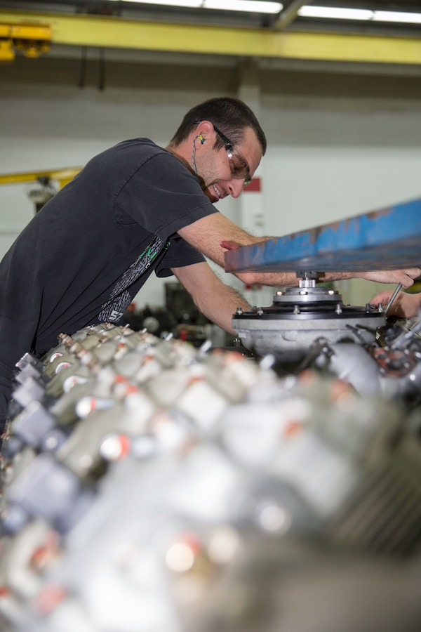 Ian Bassett, heavy mobile equipment mechanic, inspects the engine of a M88A2 Recovery Vehicle at the production plant aboard Marine Corps Logistics Base Barstow, Calif. Bassett began working in the transmission component shop, before proving himself working on the Alison transmissions and now works tirelessly on the M88A2 engines.