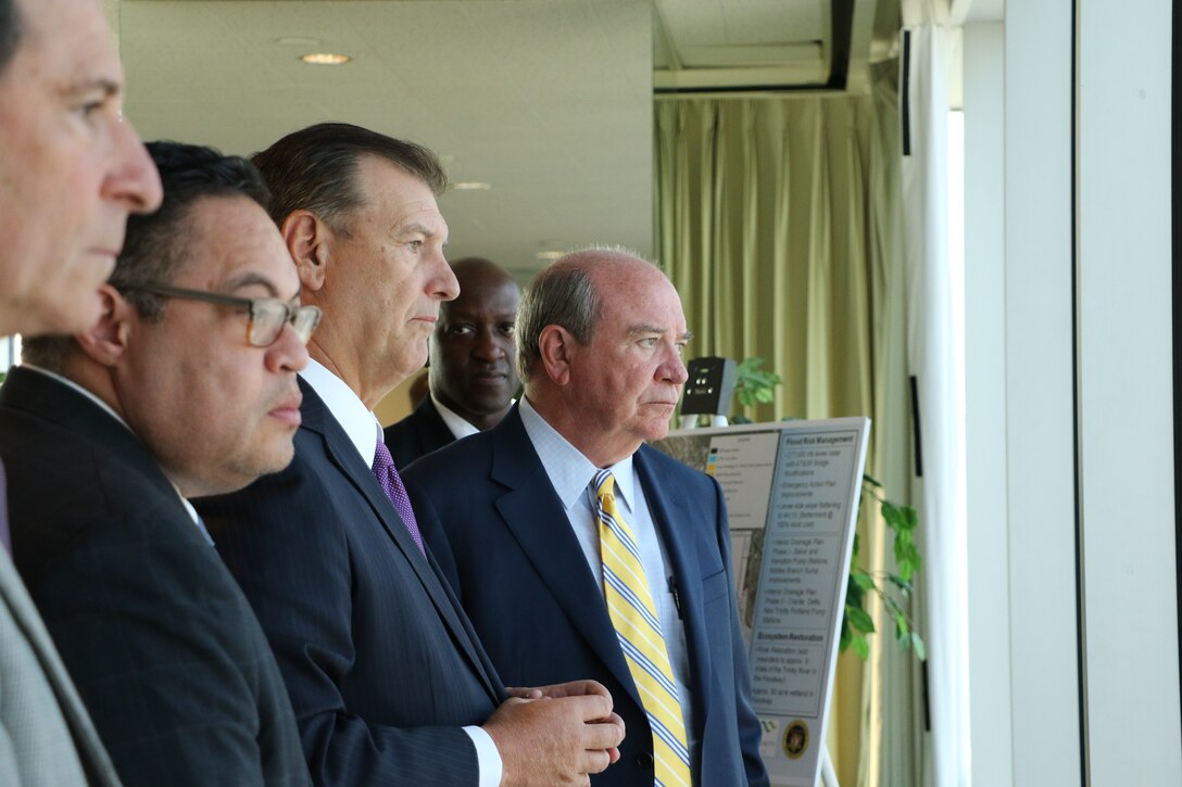 Dallas Mayor Mike Rawlings (center) looks over the Dallas Floodway from the City Club Dallas with Assistant Secretary of the Army for Civil Works R.D. James (right) along with Fort Worth District Commander Col. Kenneth N. Reed, the city of Dallas and U.S. Army Corps of Engineers representatives.