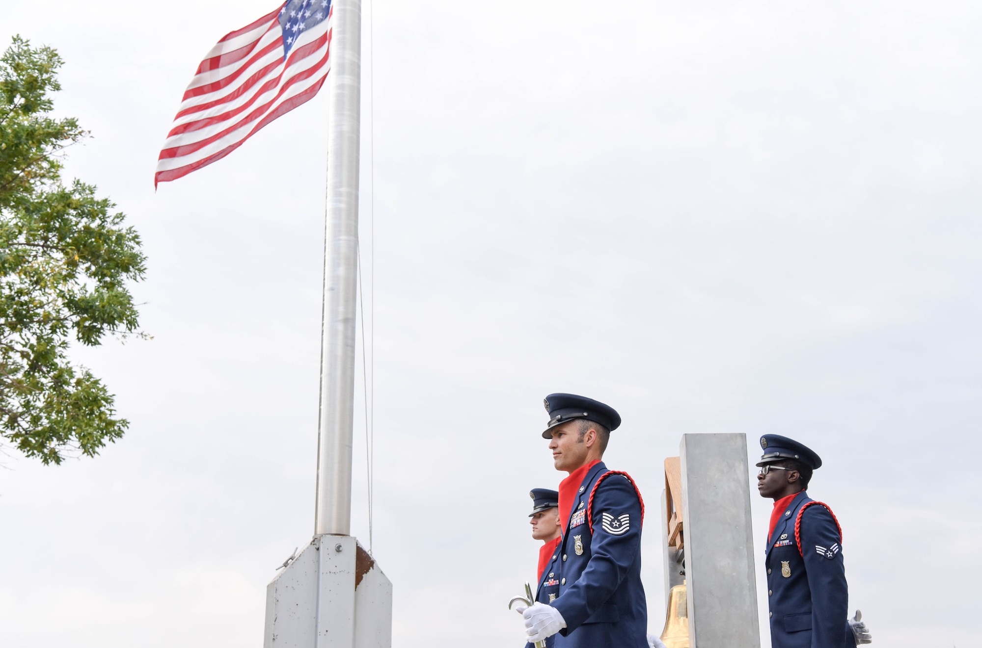 Members of the 28th Civil Engineer Squadron fire department stand for a moment of silence outside of the 28th Bomb Wing headquarters at Ellsworth Air Force Base, S.D., Sept. 11, 2018. The flag is flown at half-staff in honor of the people that lost their lives as a result of the 9/11 terrorist attack. (U.S. Air Force photo by Airman Christina Bennett)