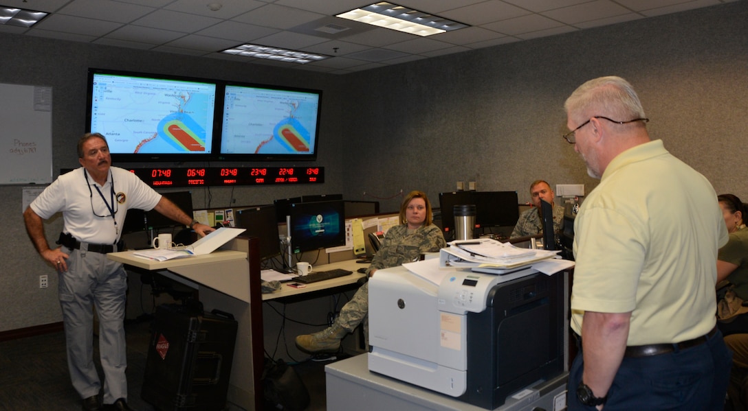 02.	Rodney Simmons, National Security Emergency Preparedness director, Air Forces Northern, listens as Joe Sanders, deputy NSEP director, briefs current Hurricane Florence conditions Sept. 11 in the NSEP operations cell. From providing specialized job personnel and equipment to assigning staging areas for supplies, AFNORTH, the air component of U.S. Northern Command, continues to assist that command’s support of the Federal Emergency Management Agency’s Hurricane Florence relief efforts. (Air Force photo by Mary McHale)